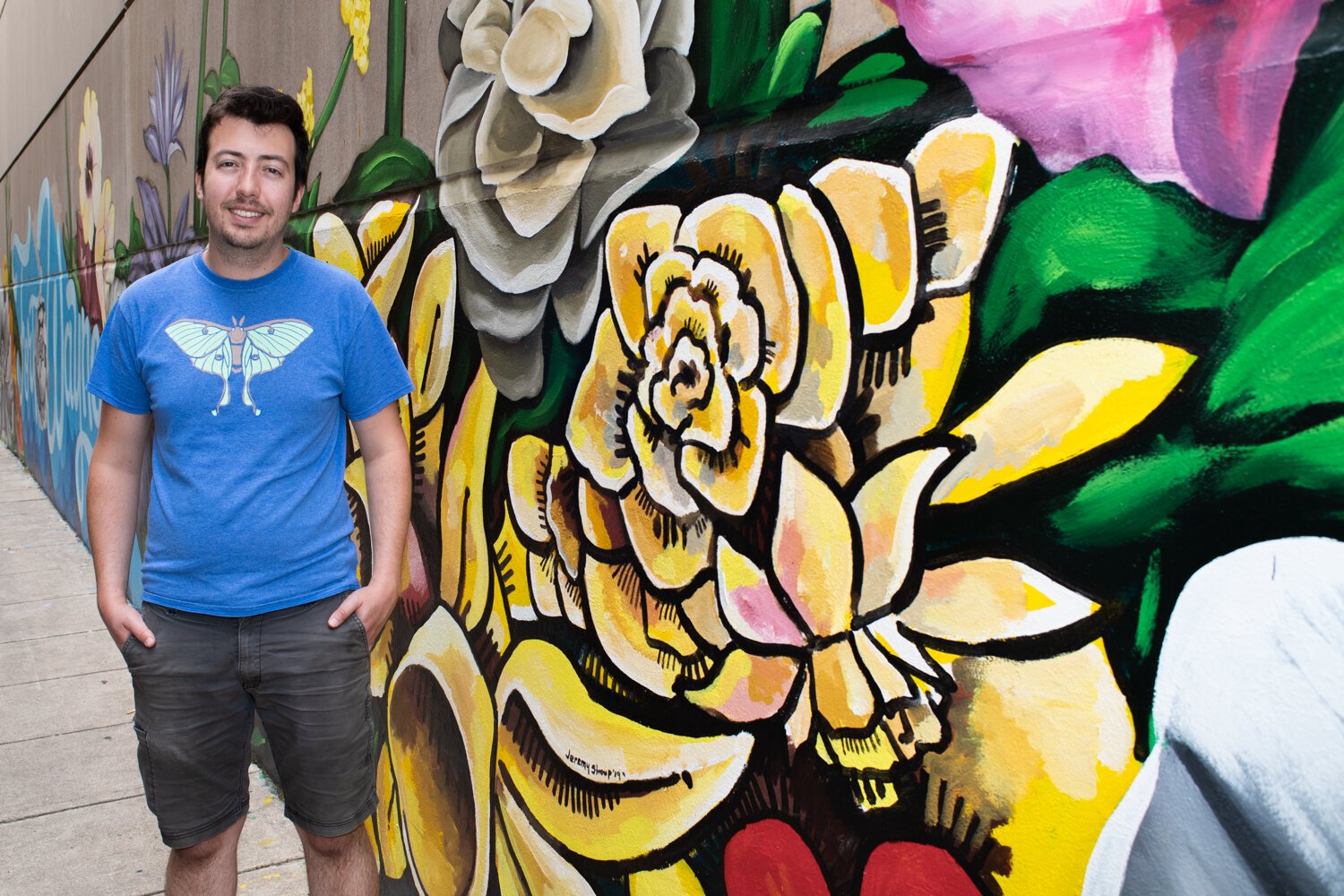 Jeremy Stroup helped artist Shawn Dunwoody with the "Hello" mural in the alley at 120 W. Wayne St. in downtown Fort Wayne.