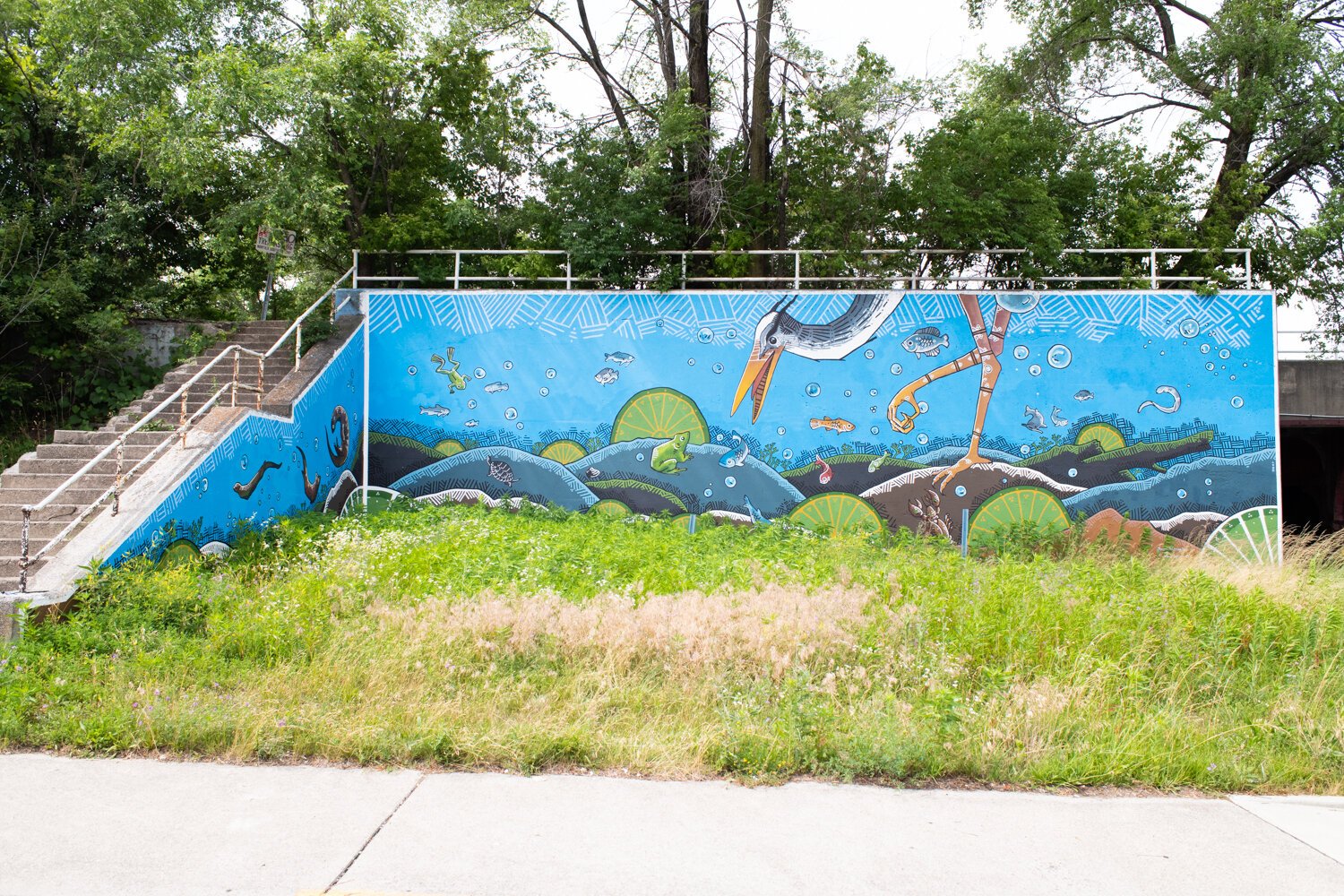 Jeremy Stroup painted an Art This Way mural of his own called “Blue Diver” in 2020 on a railroad underpass at Grand and Calhoun Streets.