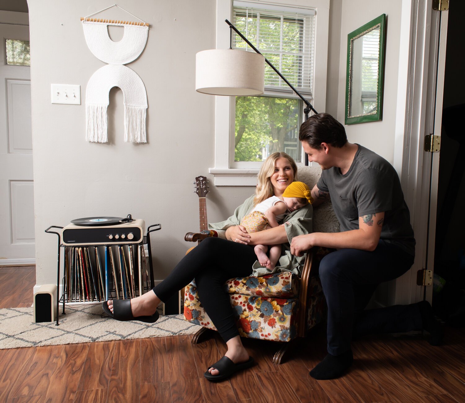 Katie Fyfe and her fiancé, Andy Gelwicks, with their 8-month-old daughter, Poppy, in their living room. 