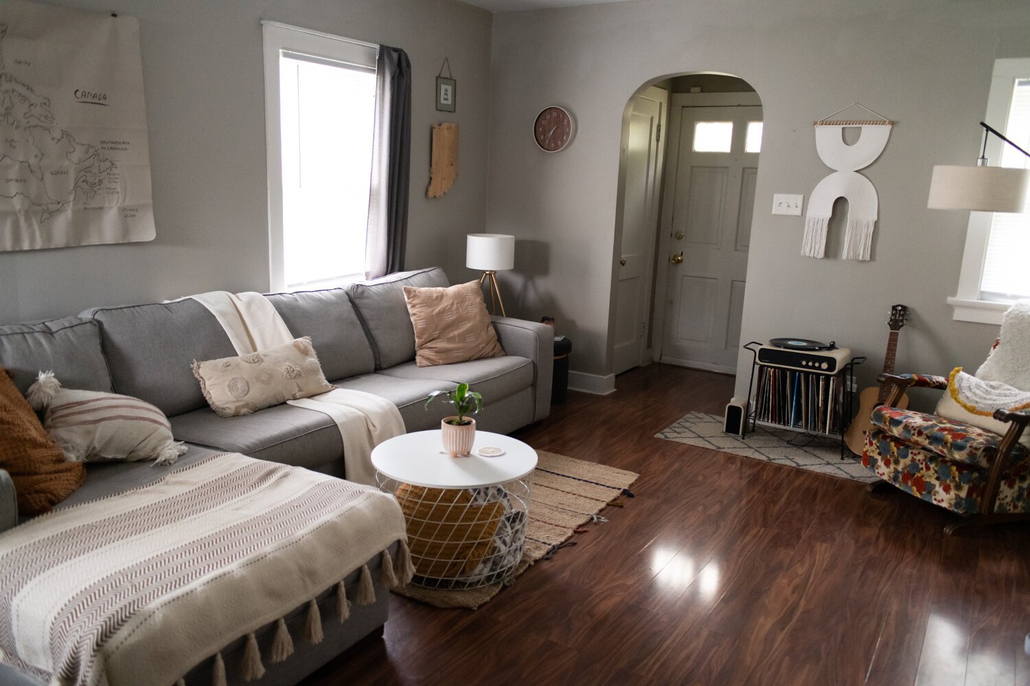 The living room has a modern, bohemian style of decor. 