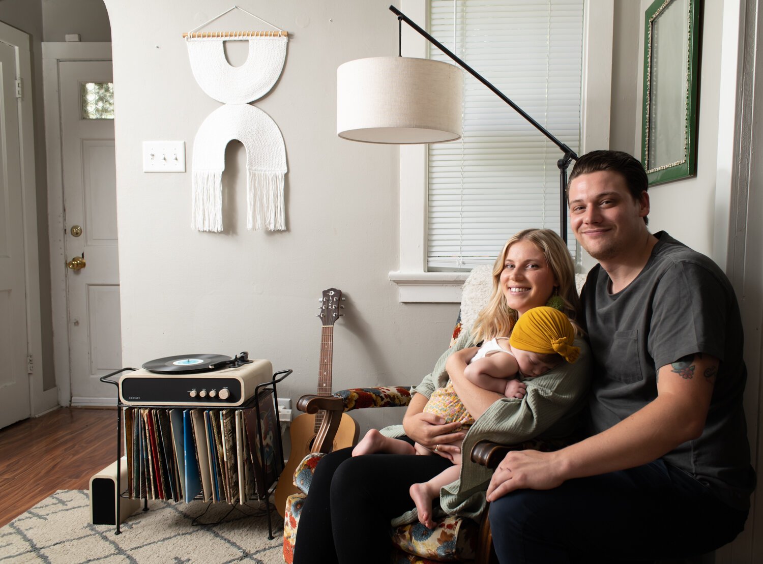 Katie Fyfe and her fiancé, Andy Gelwicks, with their 8-month-old daughter, Poppy, in their living room. 