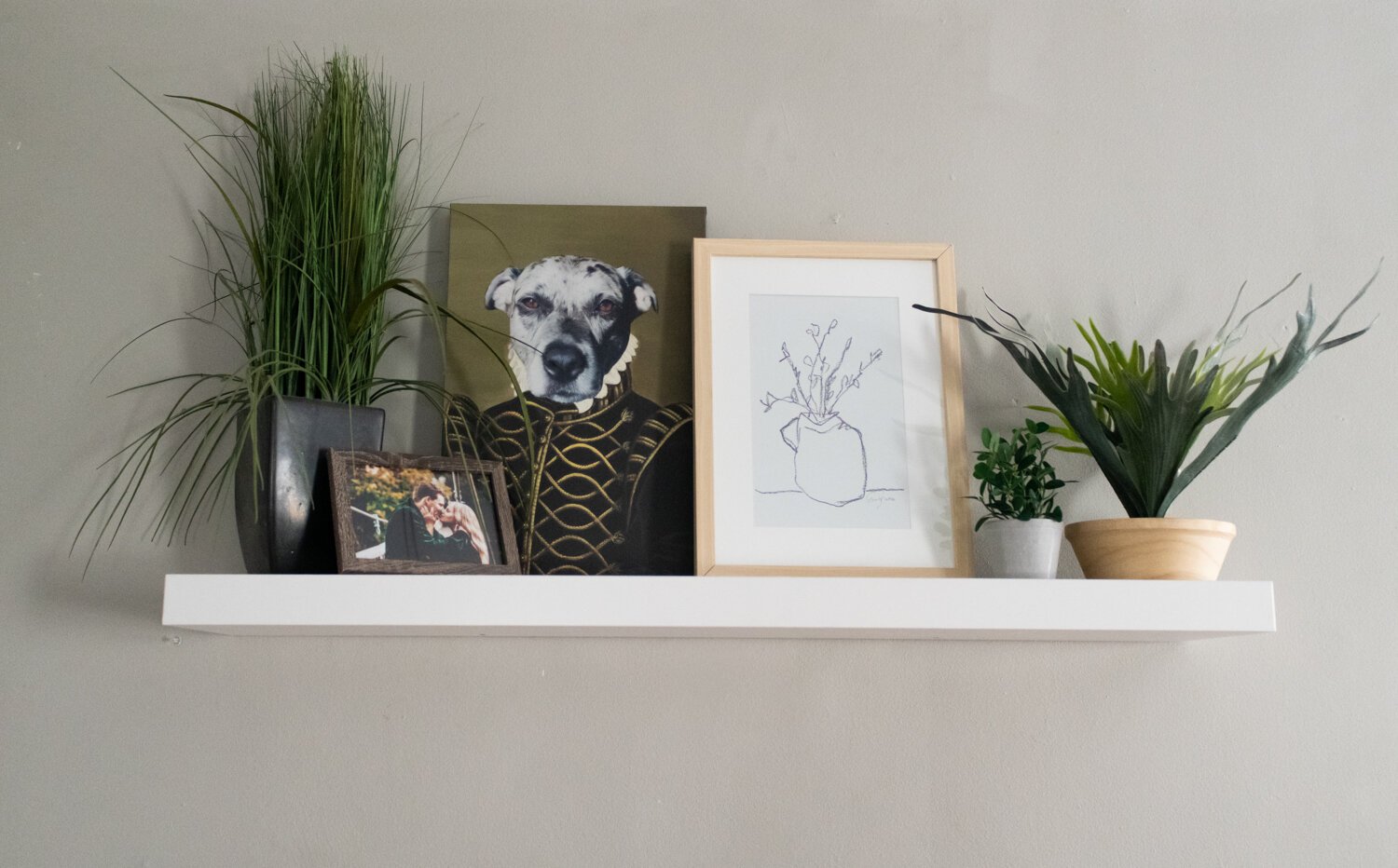 A hanging shelf, including a digital painting of the family dog Coda.