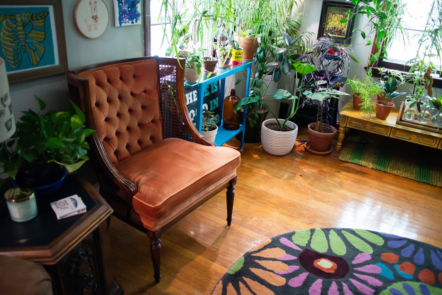 An orange chair from their friends/landlords is a feature in their living room.