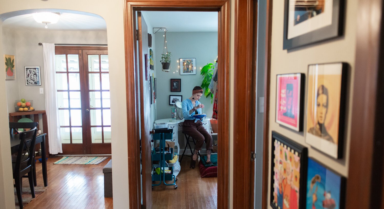 Tobi Newson works on embroidery at home.