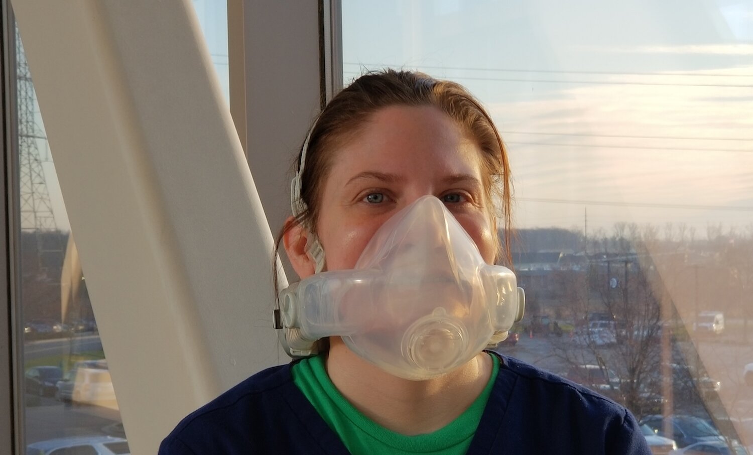 Kelsey Brown, Environmental Services Technician, models a high acuity, limited operability (HALO) ventilator system.