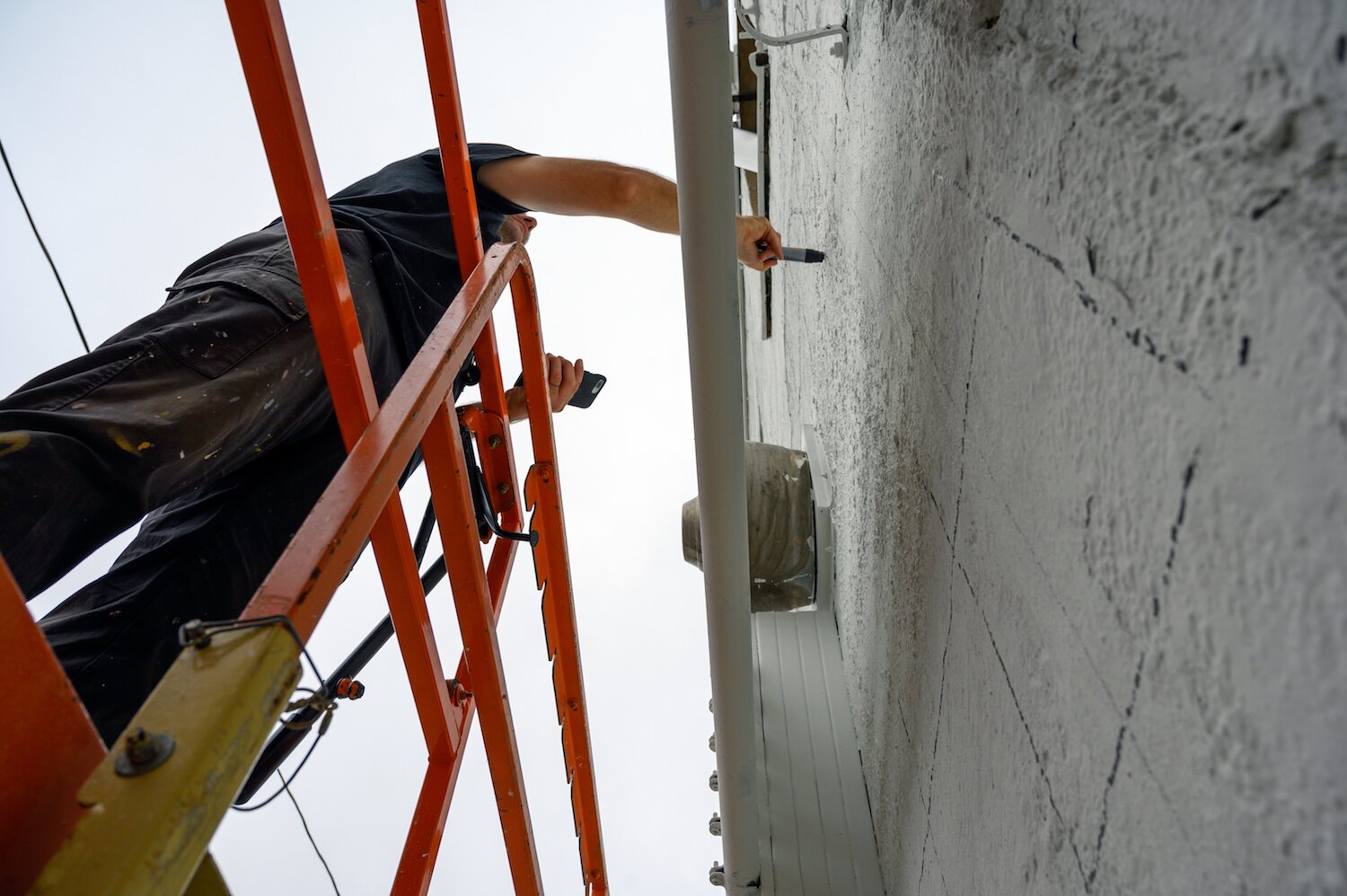 Key Detail works on a mural in downtown Fort Wayne.