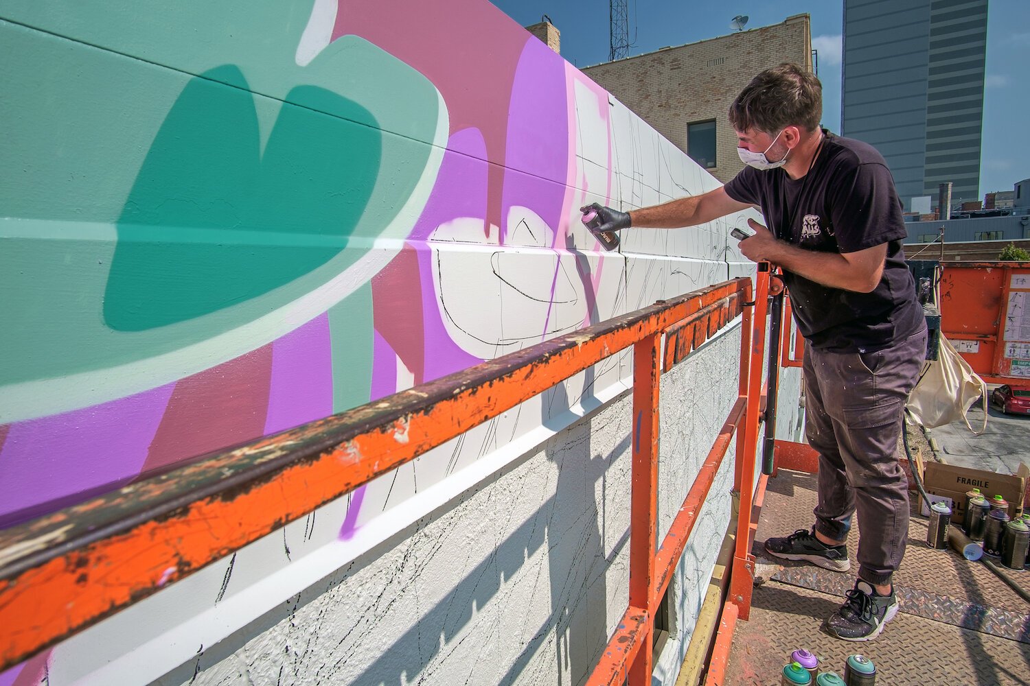 Key Detail works on a mural in downtown Fort Wayne.