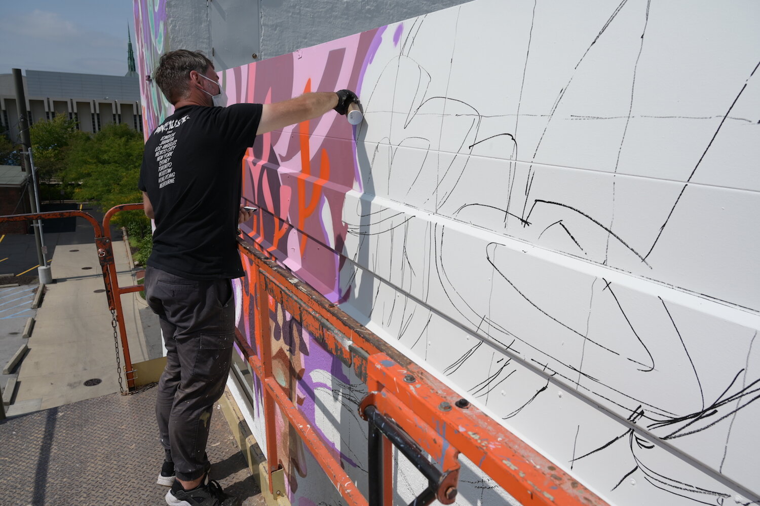 Key Detail works on a mural in downtown Fort Wayne.