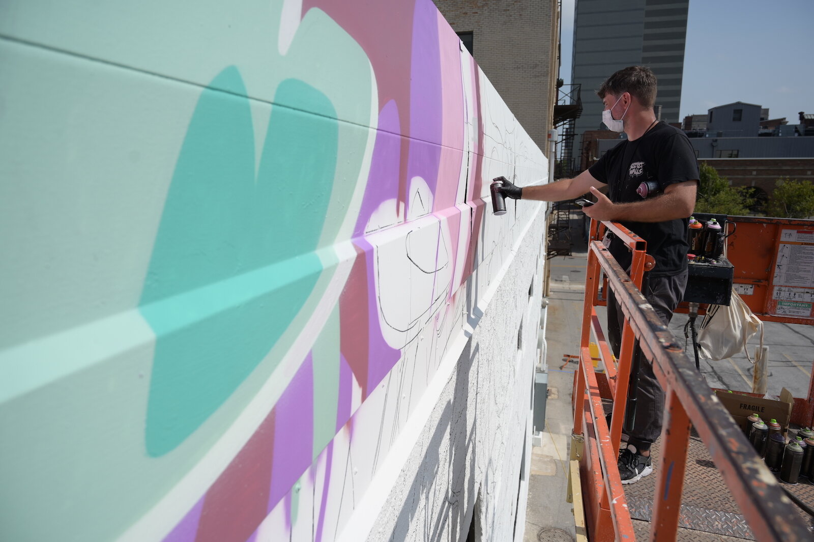 Key Detail works on a mural in downtown Fort Wayne.