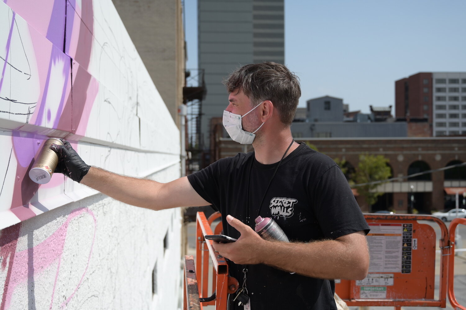 Key Detail works on a mural in downtown Fort Wayne.