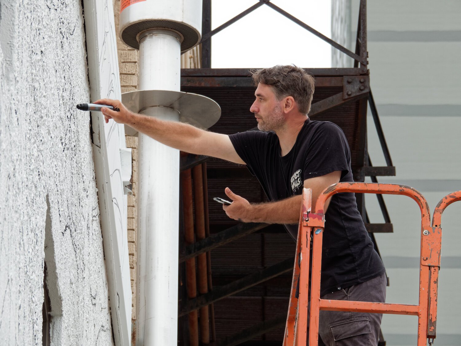 Key Detail works on a mural in downtown Fort Wayne.