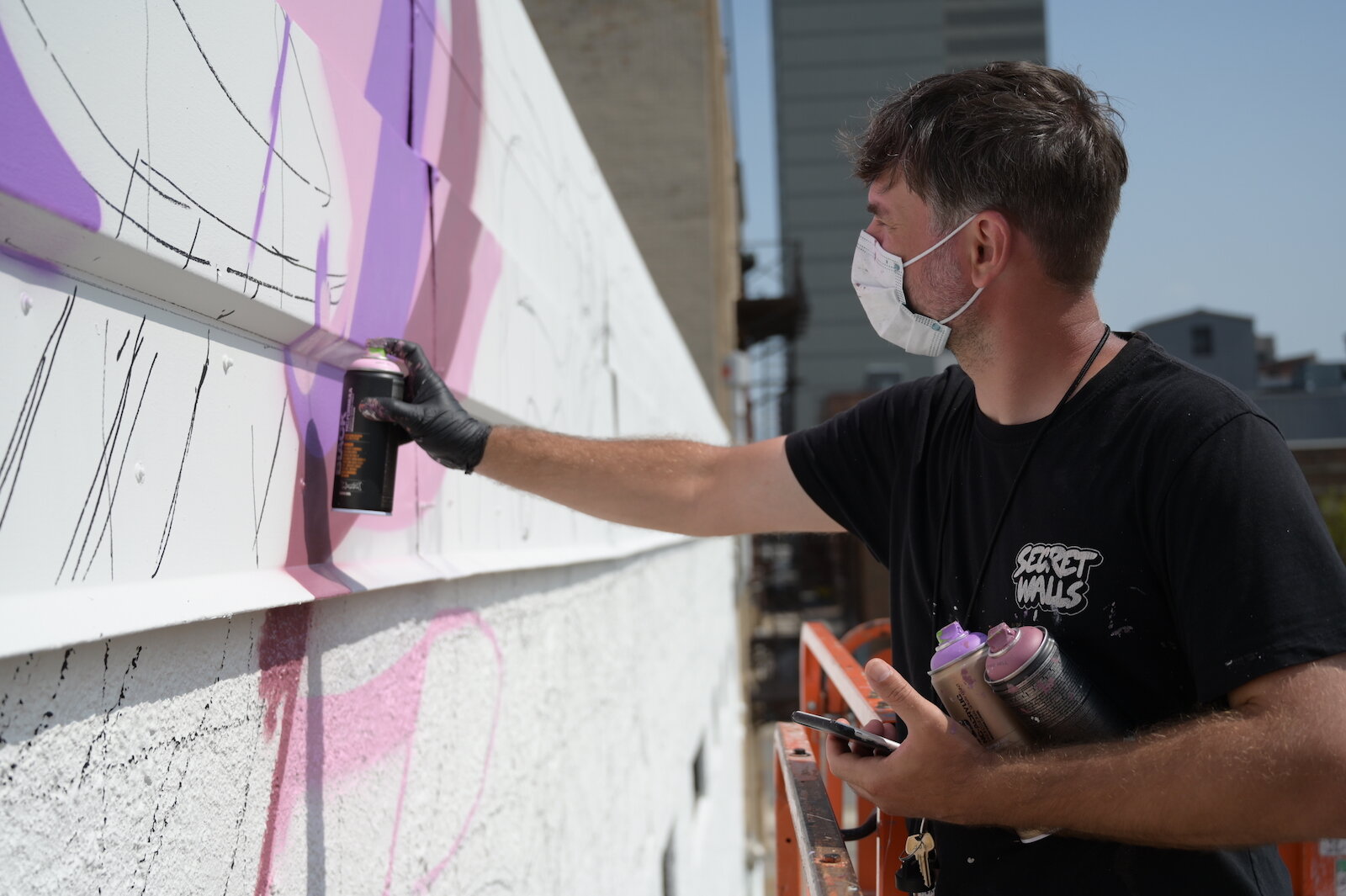 Key Detail works on a mural in downtown Fort Wayne.