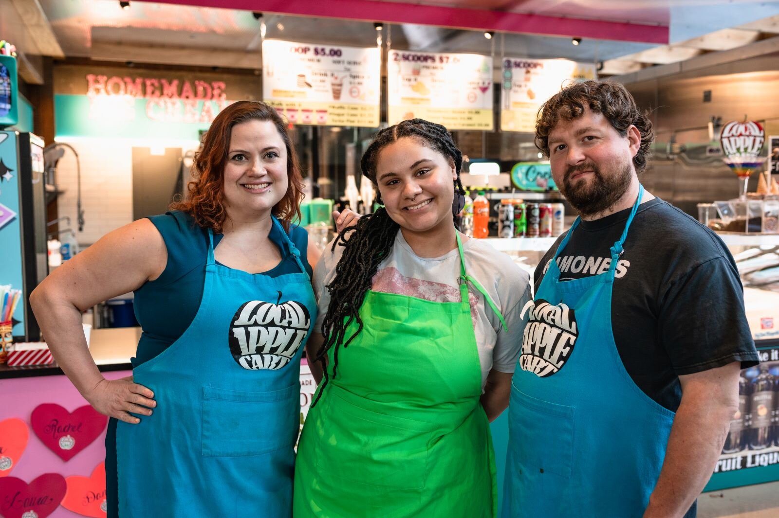 Left to right: Rachel Nally, Laura Mudd, Dan Figley in front of Local Apple Cart in the Union Street Market.