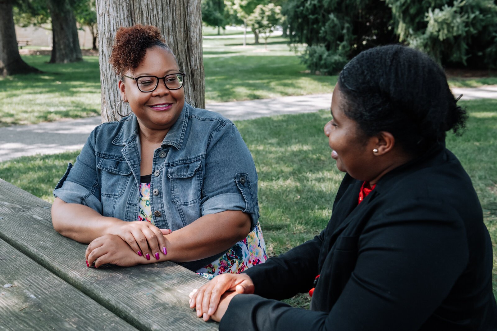 LaQueisha Brown, right, and Myla Rogers, left, catch up with one another at Lakeside Park.