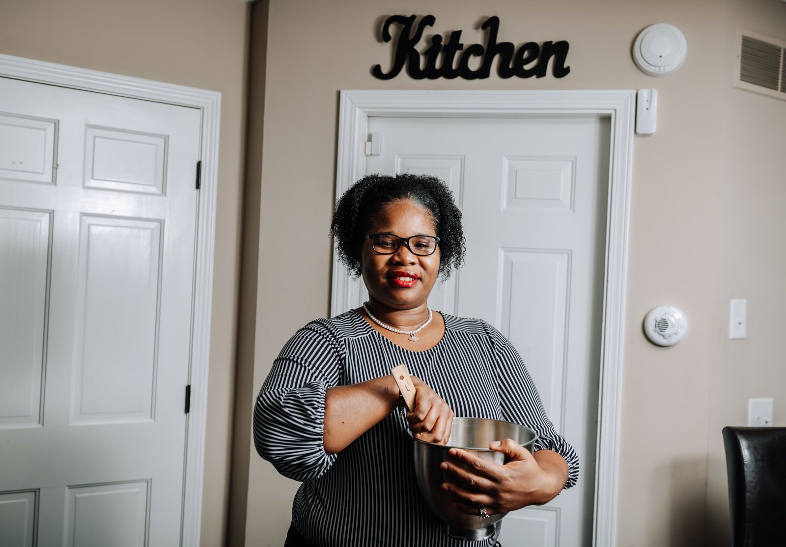 LaQueisha Brown cooking in her home kitchen.