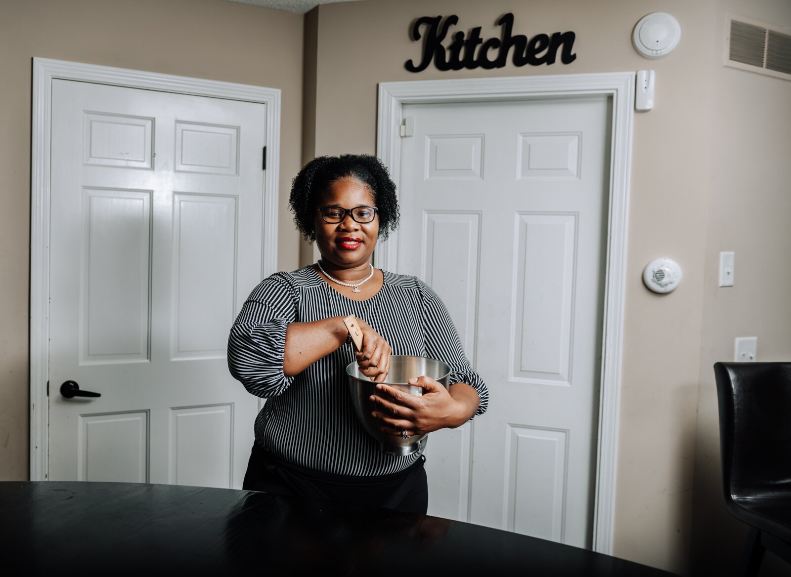 LaQueisha Brown cooking in her home kitchen.