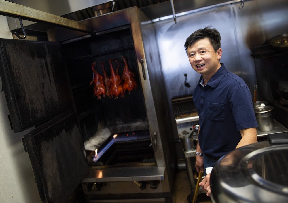 Lee Truong stands by his famous seasoned duck at West Coast Grille on South Calhoun Street.