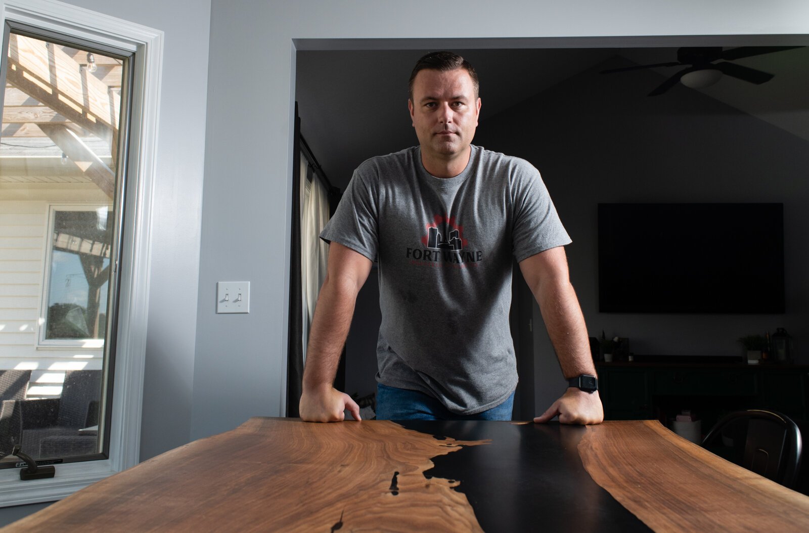 Lee Hoffmeier, Founder of Fort Wayne Industrial Revolution, with one of his custom tables at his home in Fort Wayne.