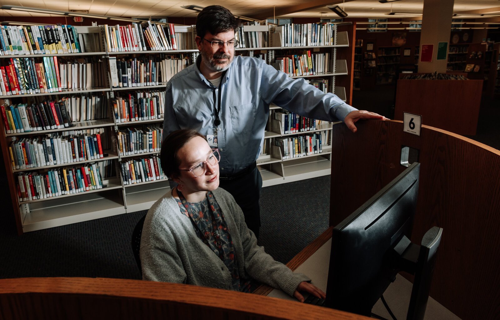 Branch Manager Christopher R. Wiljer helps Librarian Kristina Lay with the computer at the Allen County Public Library's Monroeville branch.