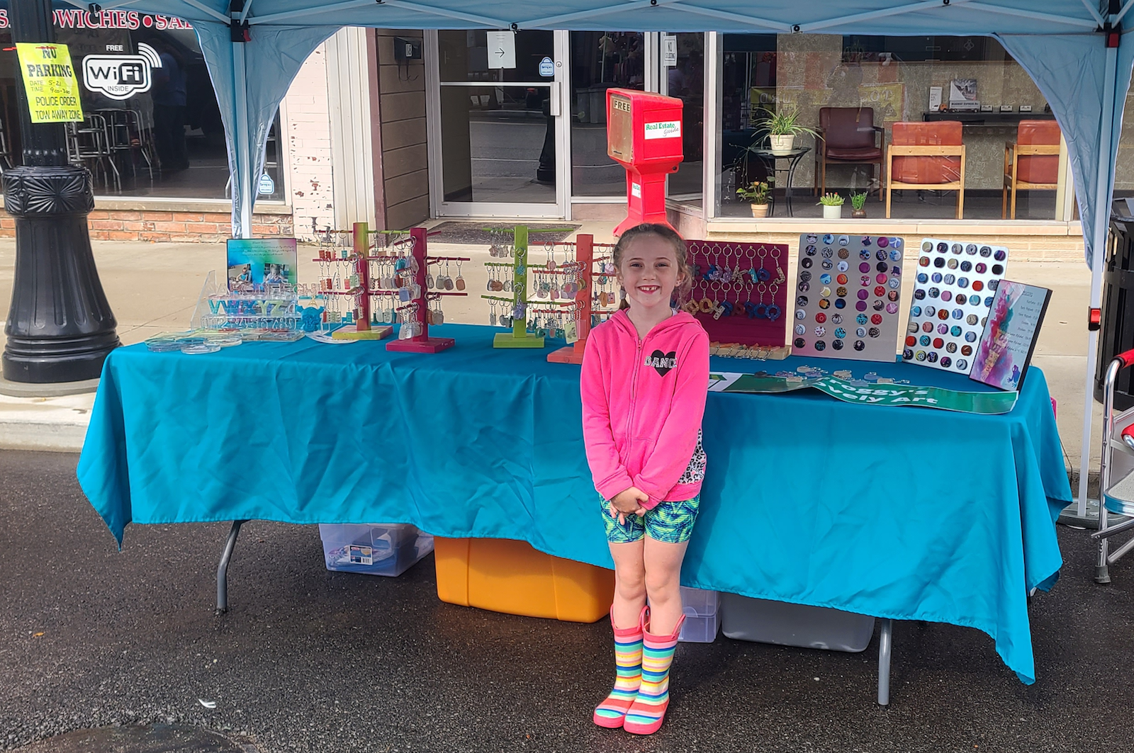 Lilly's family helps her run Froggy's Lovely Art booth at events.