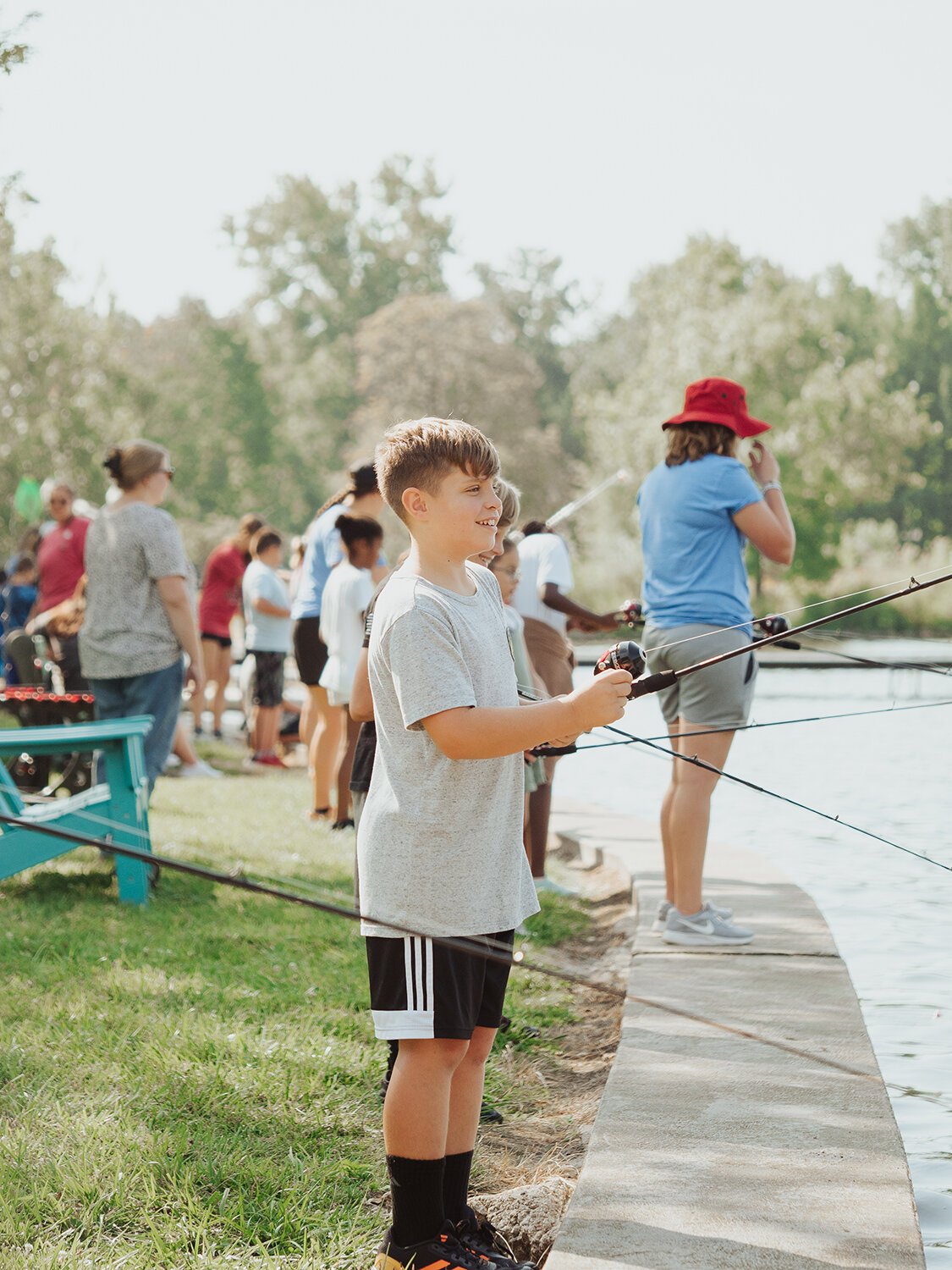 Student reels in a catch at fishing education event with  The Lilly Center for Lakes and Streams.