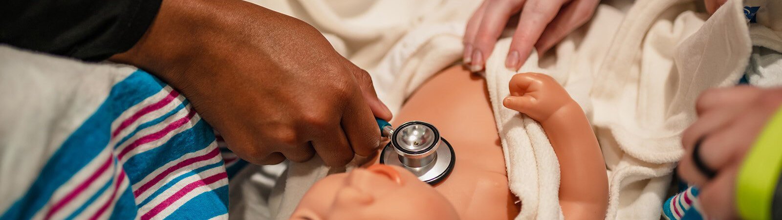 An IUFW nursing student simulates taking vitals on an infant at Parkview.