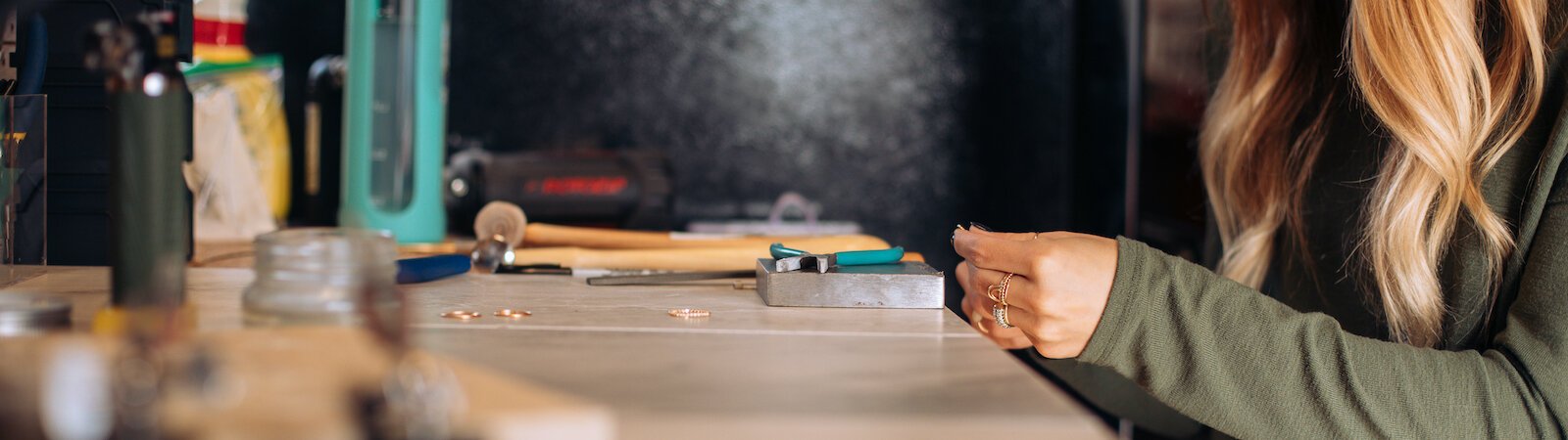 Still Remains Owner Raelyn Bever works on a ring in her garage workspace.