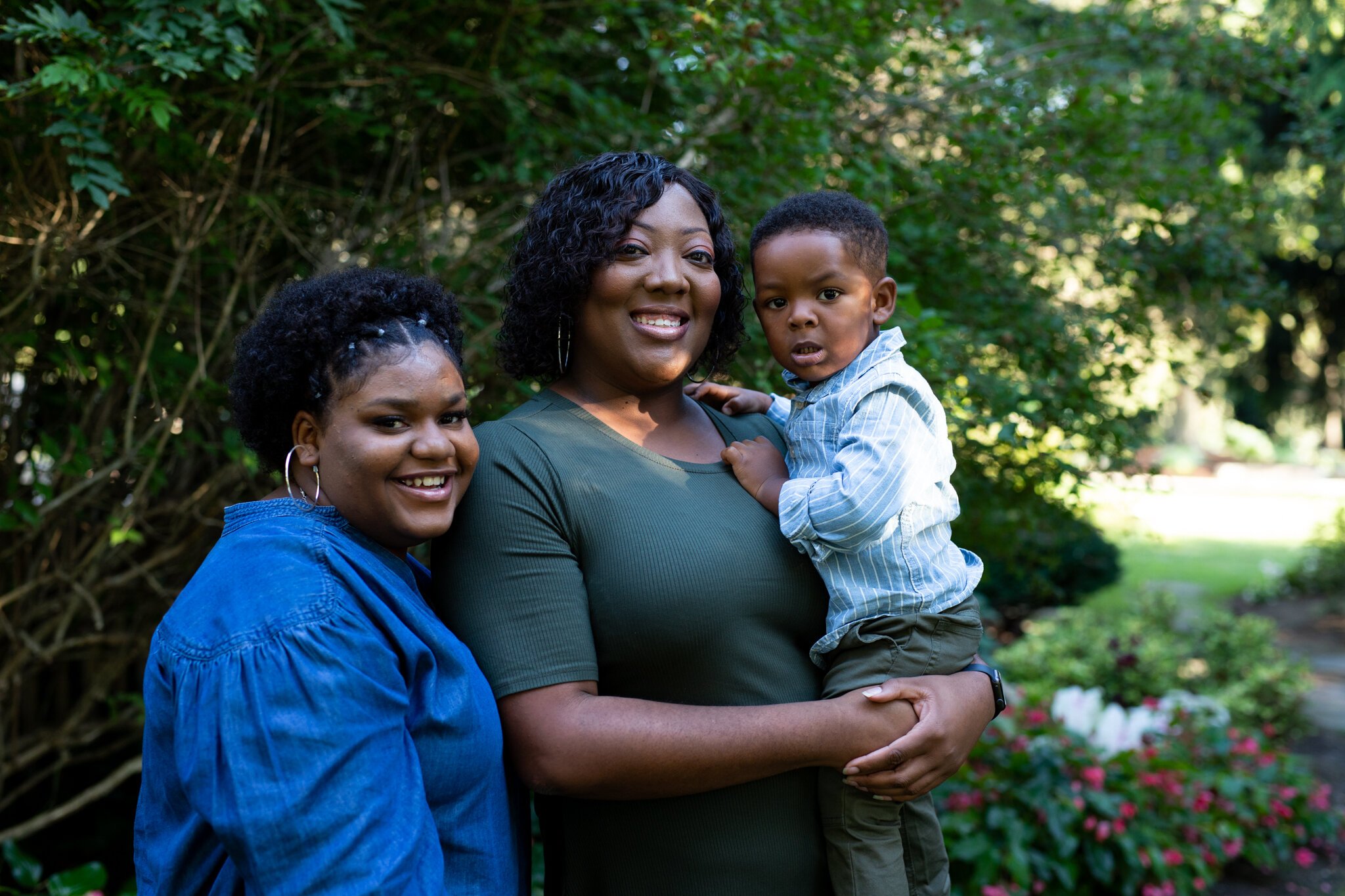 Lakisha Woods, center, her 17-year-old goddaughter Ariana, left, and her 2-year-old son Jaxon, right.