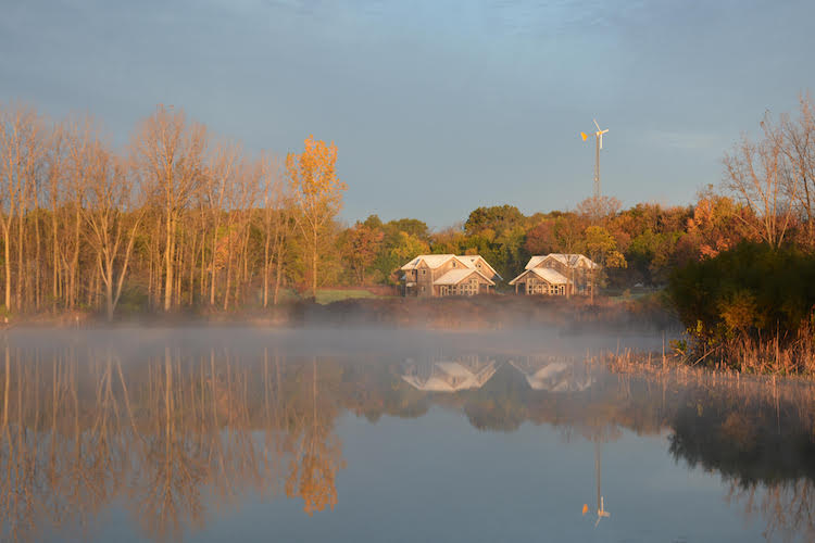 Merry Lea's Rieth Village is reflected in the Kesling Wetland, a nine-acre wetland restoration.