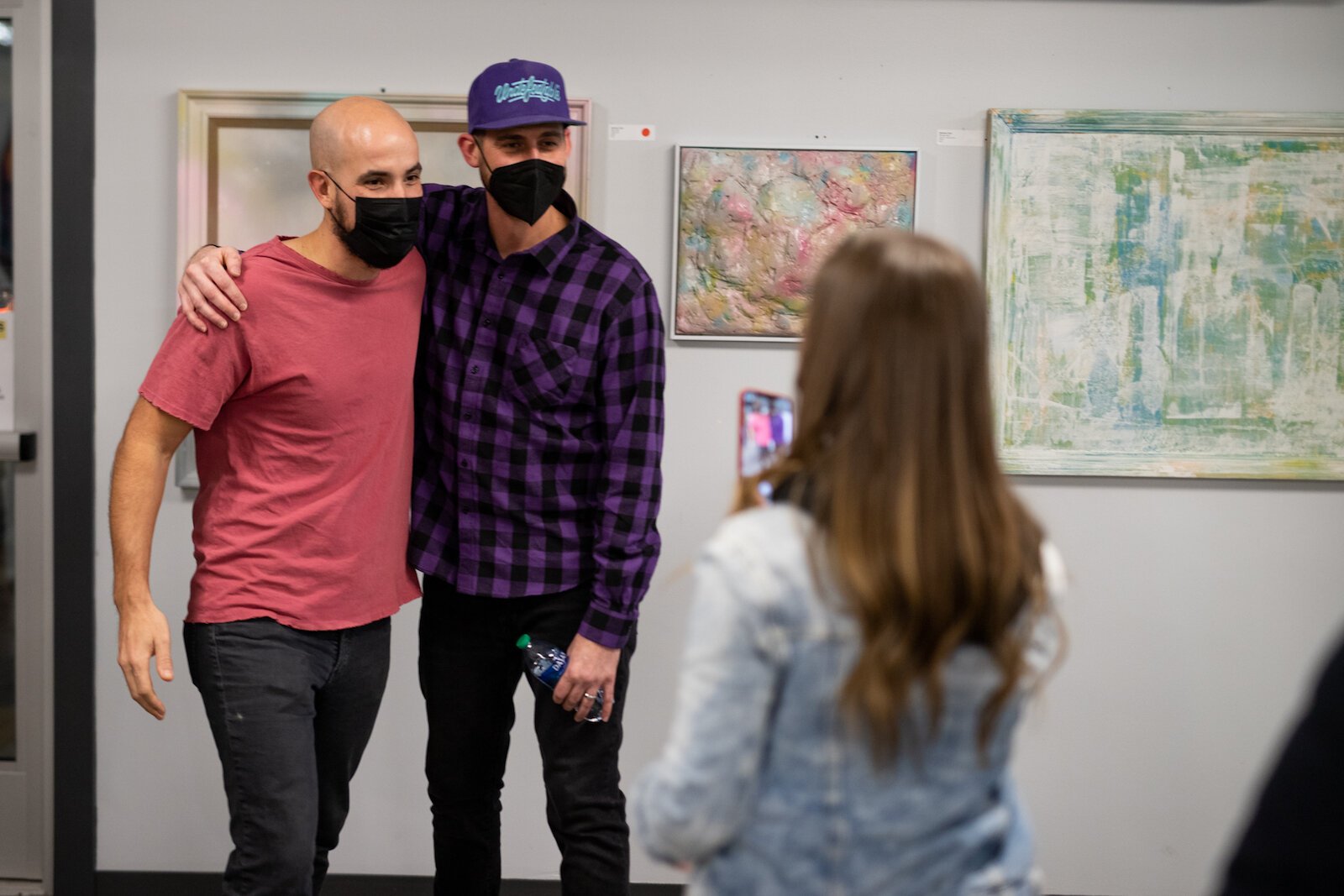 Matt Plett, right, poses with guests on the opening night of his art show, “It's OK. It's OK? It's OK!” held at the Garden January 13-27.