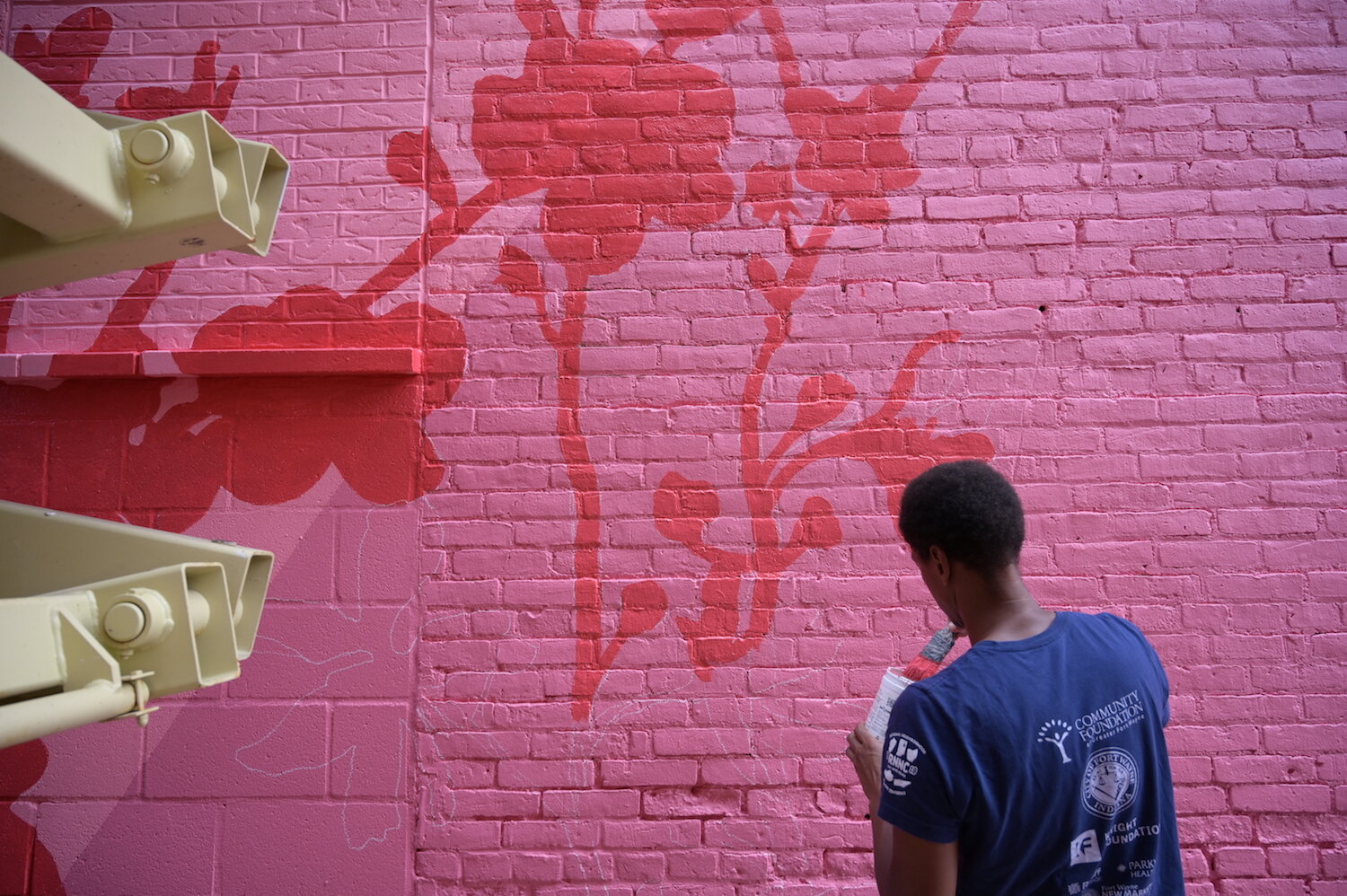 Shawn Dunwoody works on a mural in downtown Columbia City.