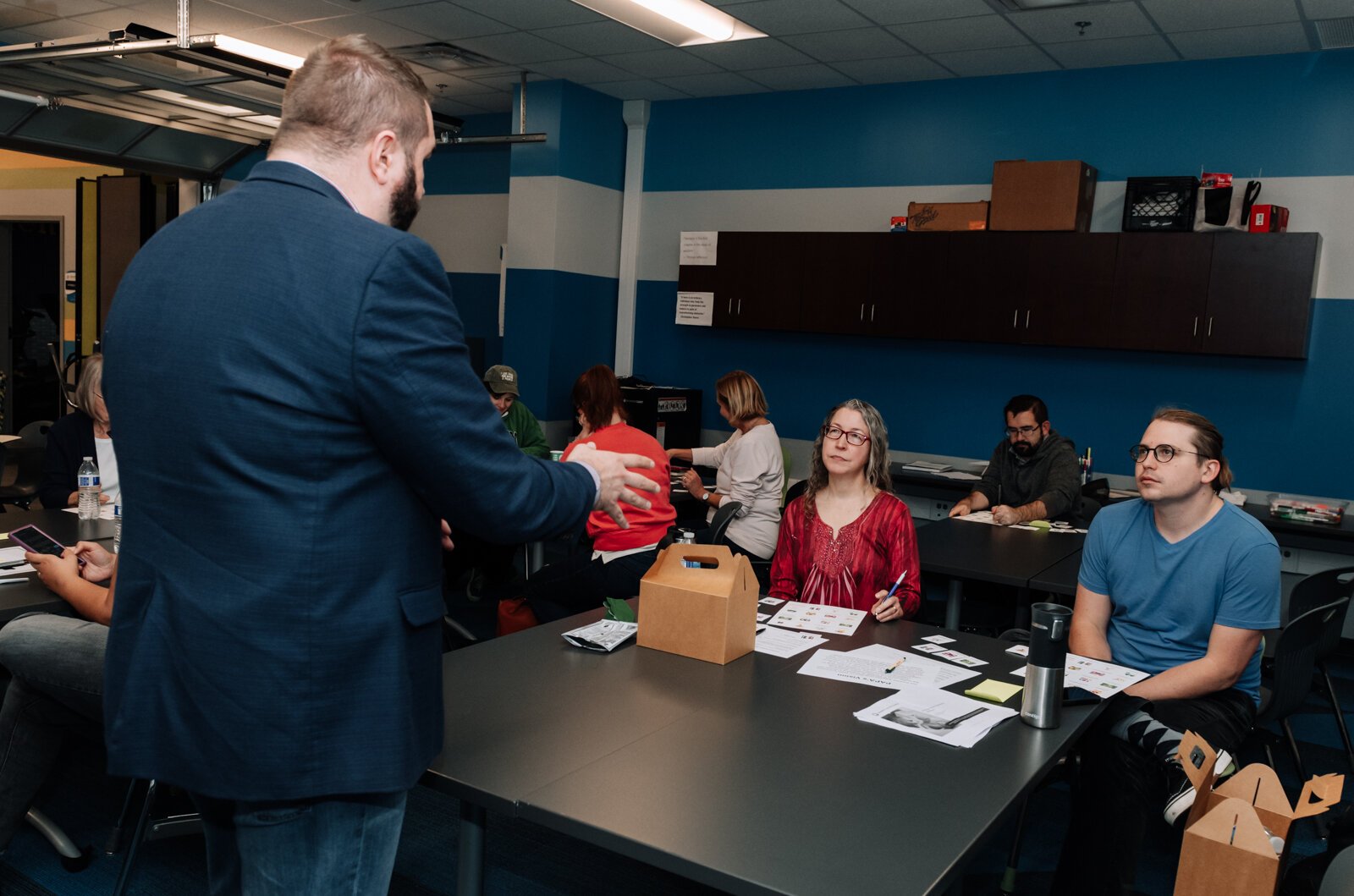 Dan Baisden talks with residents Victoria Sprague, left, and John Renz during the Packard Area Planning Alliance retreat at the Boys and Girls Club on Fairfield Ave.