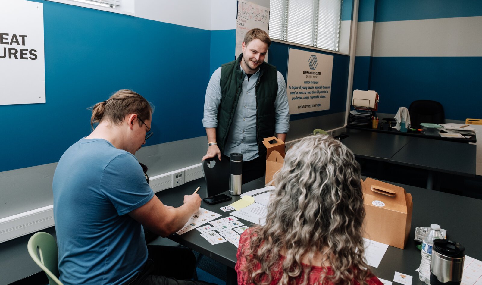 Josh Campbell talks with residents Victoria Sprague, right, and John Renz during the Packard Area Planning Alliance retreat at the Boys and Girls Club on Fairfield Ave.