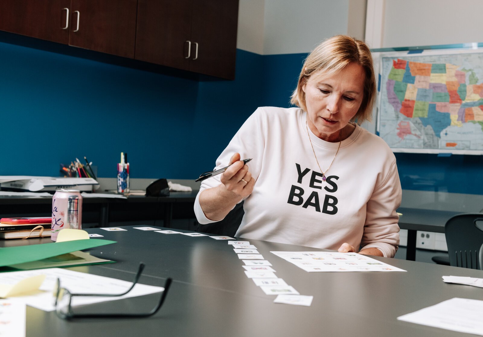 Cornelia Schulz works on filling out her board for the game Lotería during the Packard Area Planning Alliance retreat at the Boys and Girls Club on Fairfield Ave.