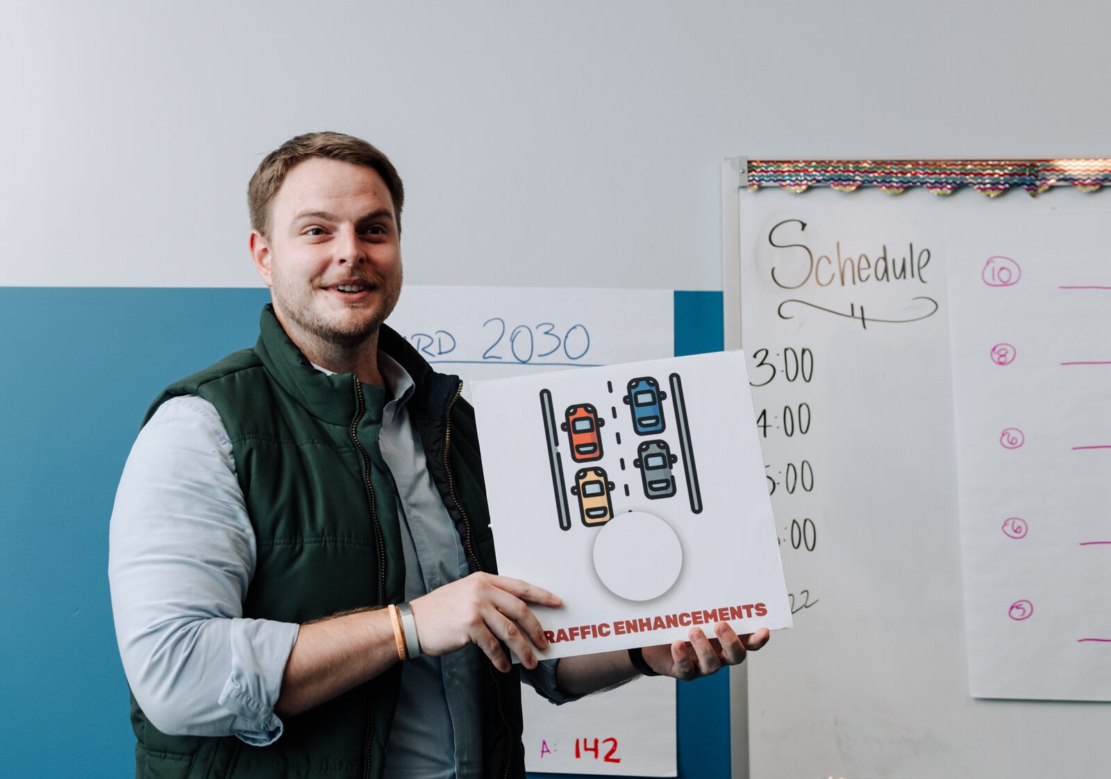 Josh Campbell holds up cards for the game Lotería during the Packard Area Planning Alliance retreat at the Boys and Girls Club on Fairfield Ave.