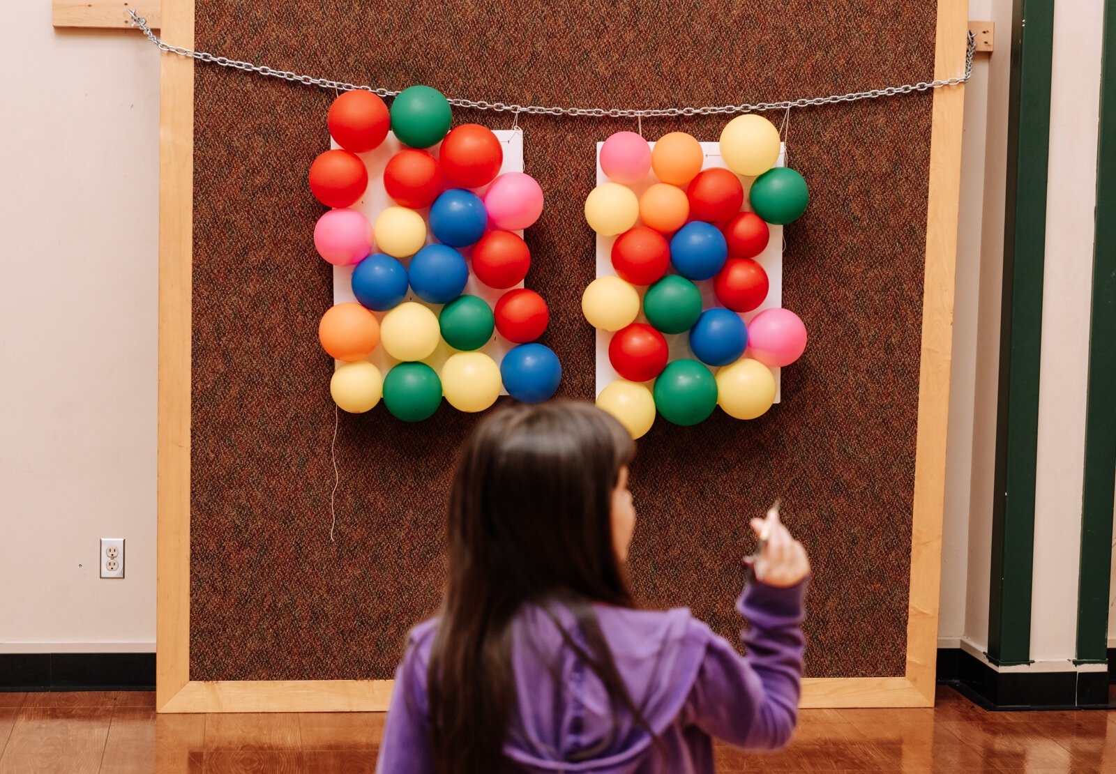 A child plays one of the available games during the Fall Fest event at Harvester Missionary Church.