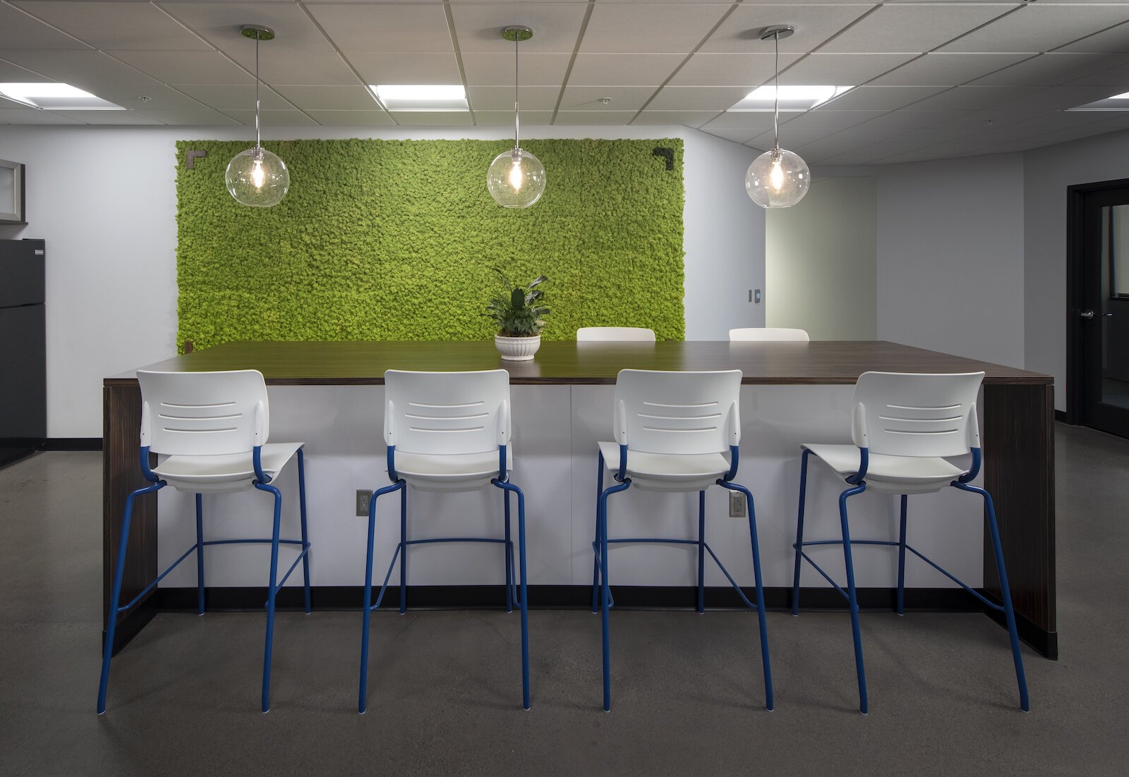 In its work with the Northeast Indiana Regional Partnership, Design Collaborative incorporated a “green wall” in the community breakroom to give employees a spark of color.