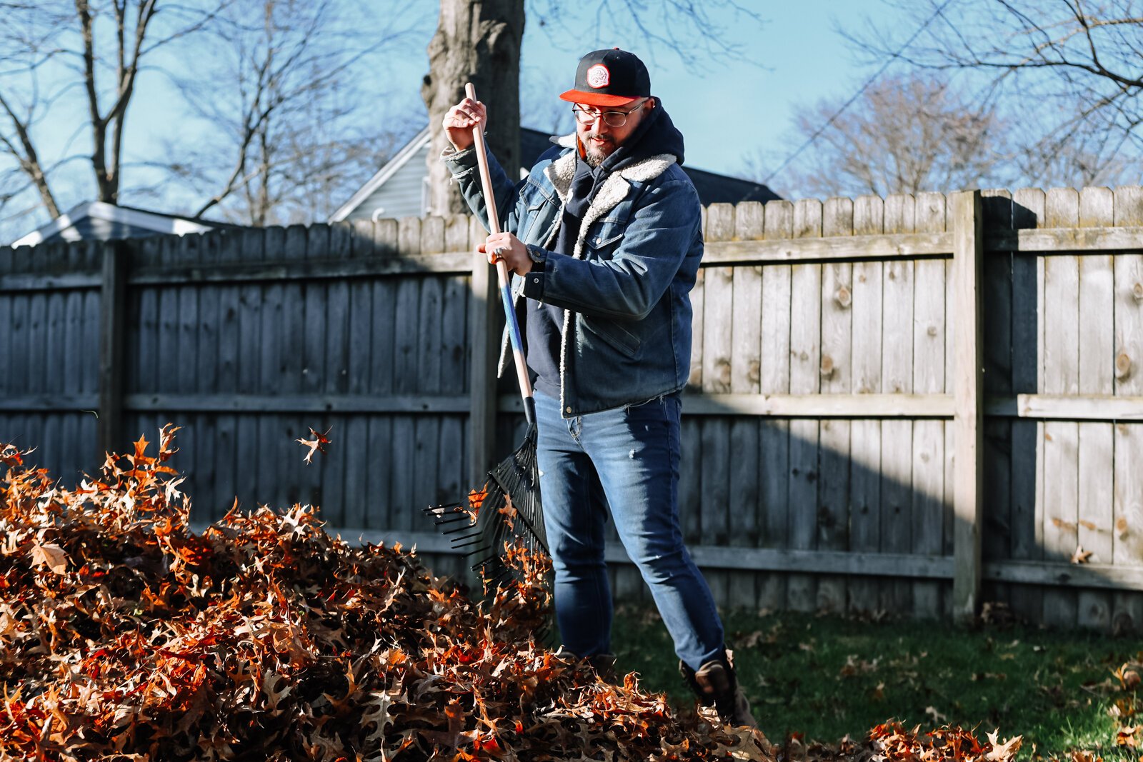 Eric Wood, Executive Director of NeighborLink, helps clear leaves while volunteering at a home in Fort Wayne.