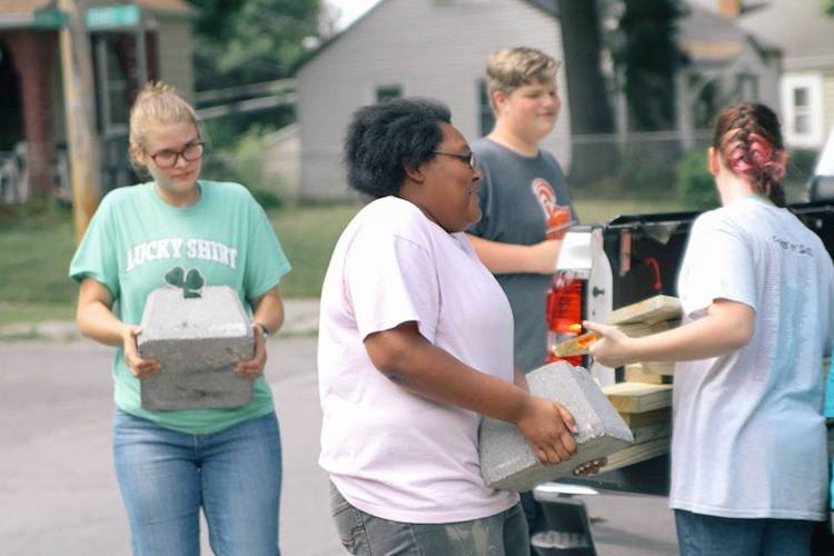 NeighborLink volunteers unload materials at a project site. The group is currently seeking COVID-19 volunteers and projects.