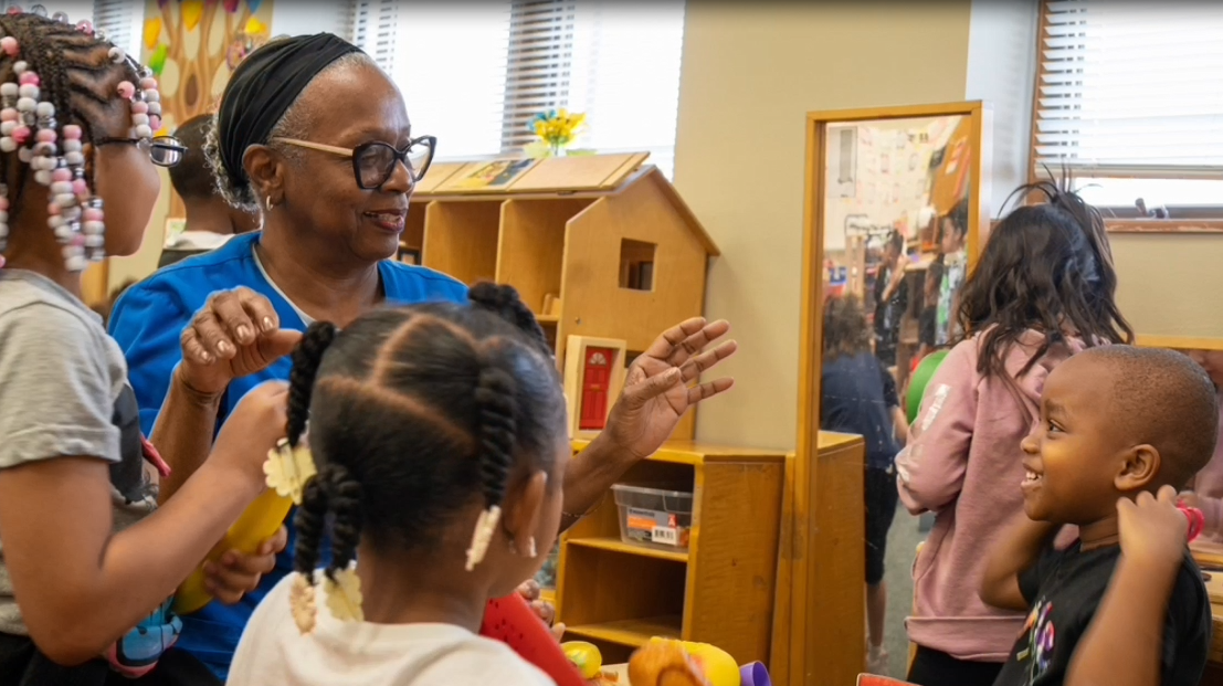 Orca, a foster grandparent, plays with the preschoolers in their classroom.