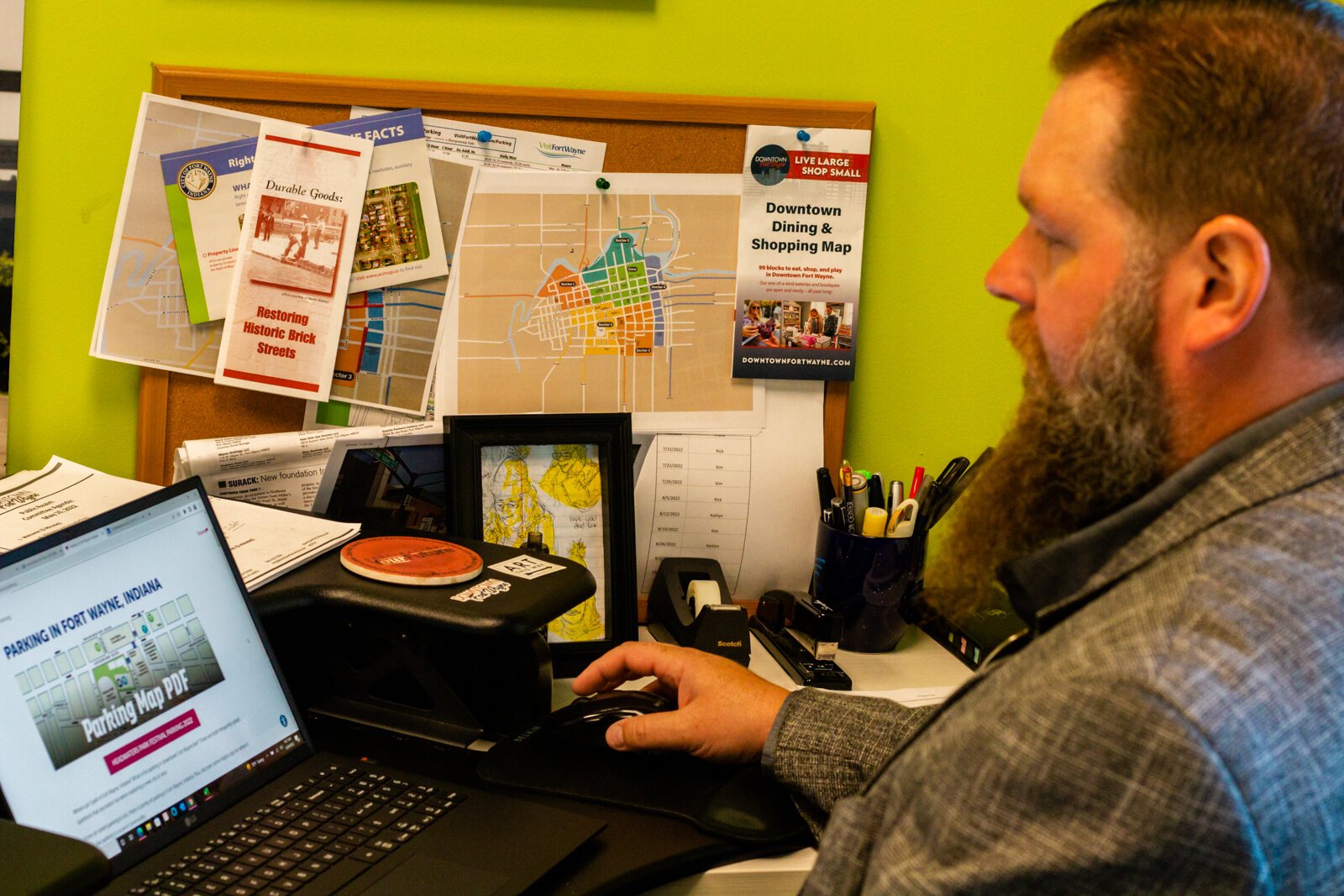 Frank Howard, Director of Operations for Downtown Fort Wayne, pulls up free, printable Downtown parking maps on his computer.
