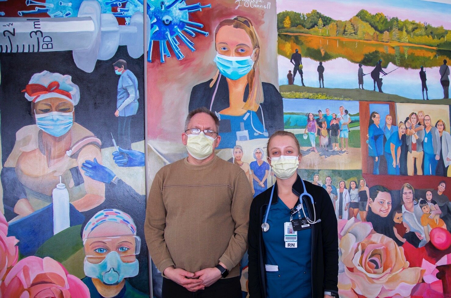 Parkview RN and artist Jason O’Connell, left, stands with one of his coworkers featured in his mural at Parkview Heart Institute.