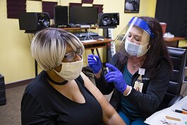 Jacqueline Barros, left, receives her COVID-19 vaccine from Judy Nix, Parkview Community Nursing. 