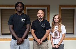 Peacemaker Academy Director, Angelo Mante, center, with two students, Dazhon Ware, left, and Caroline Shroyer, right, who are part of the program.