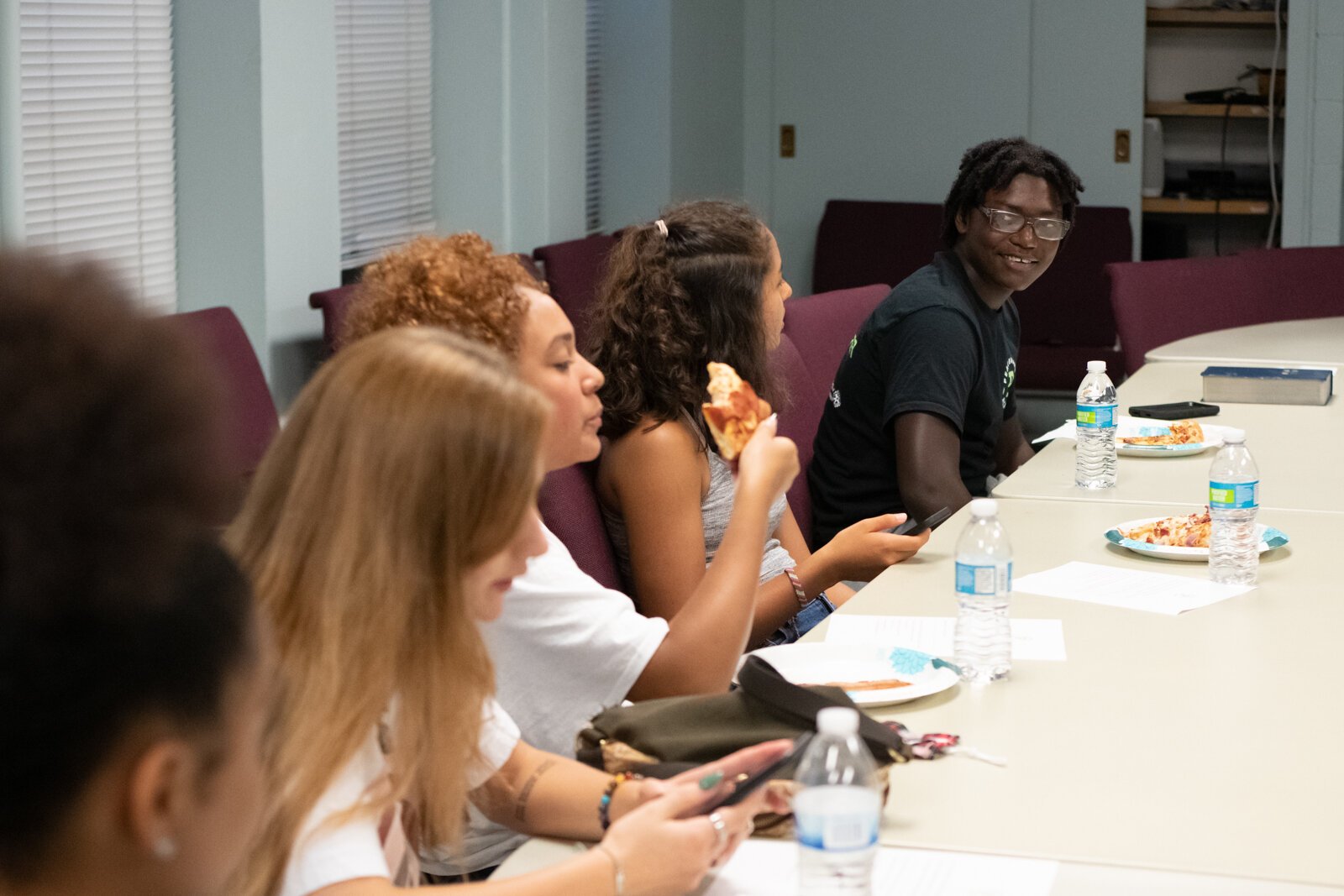 Dazhon Ware talks with fellow students who are part of the Peacemaker Academy during a meeting led by director Angelo Mante at First Wayne St. United Methodist Church.