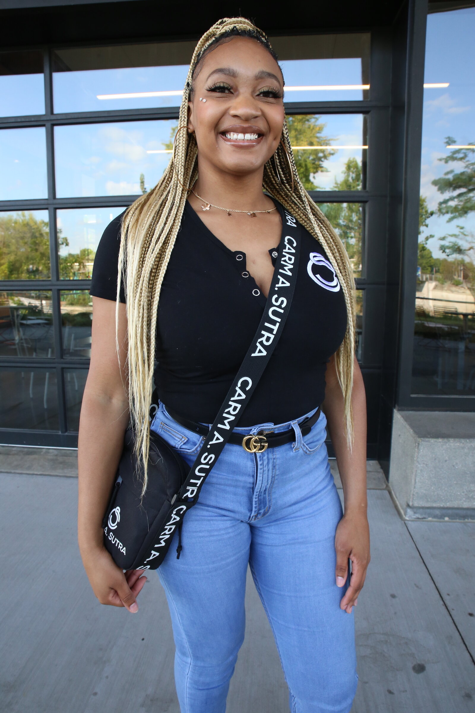 Entrepreneur Carmen Perry sports one of her popular form-fitting rompers underneath a pair of jeans with a Carm A. Sutra bag.