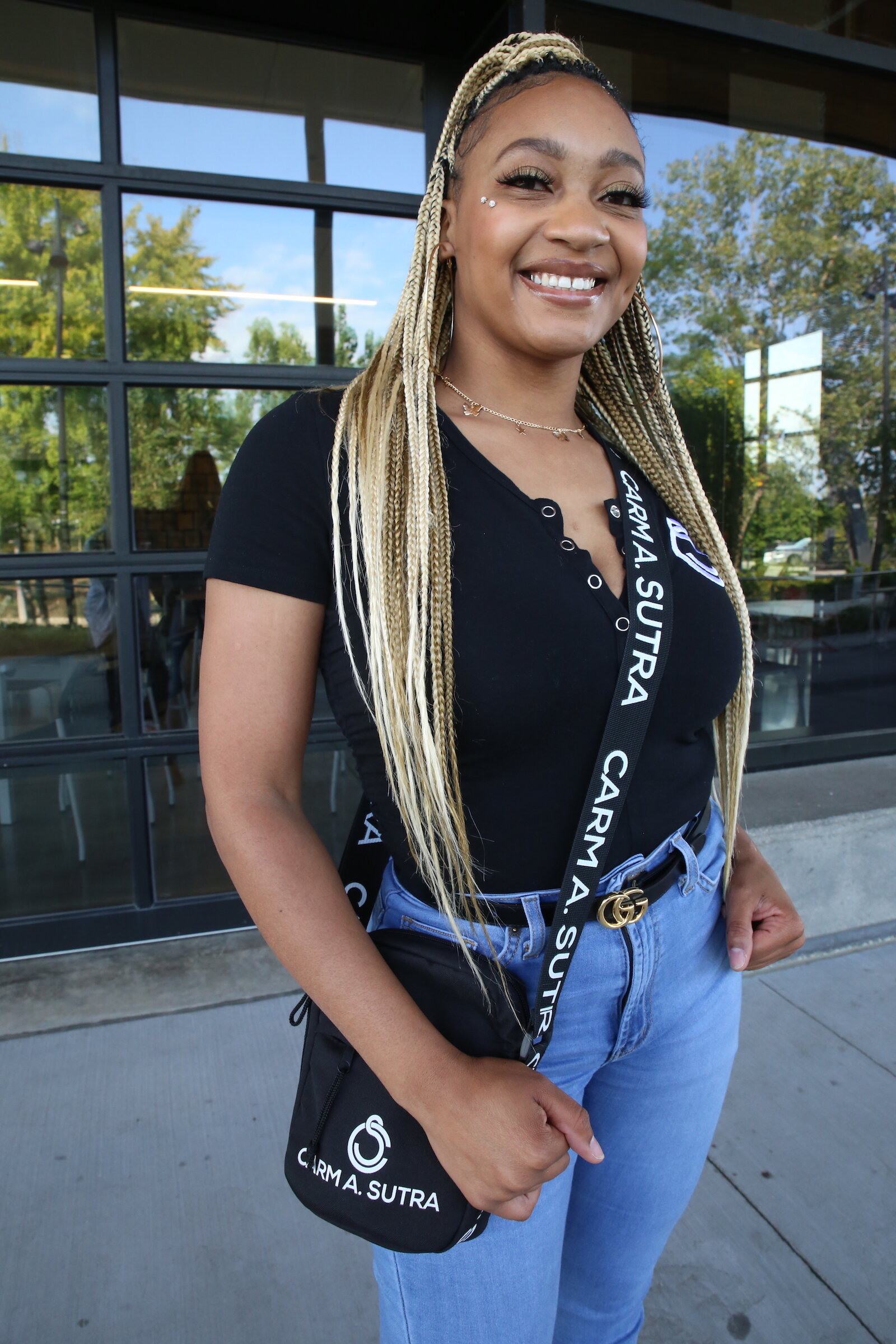 Entrepreneur Carmen Perry sports one of her popular form-fitting rompers underneath a pair of jeans with a Carm A. Sutra bag.