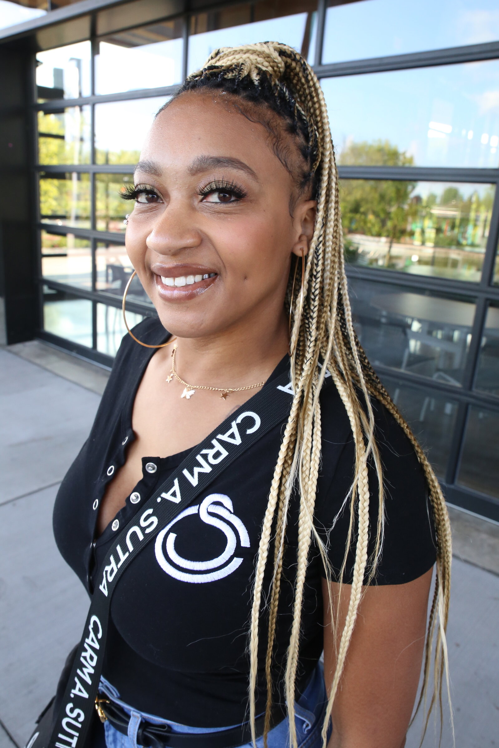 Entrepreneur Carmen Perry sports one of her popular form-fitting rompers underneath a pair of jeans with a Carm A. Sutra bag.