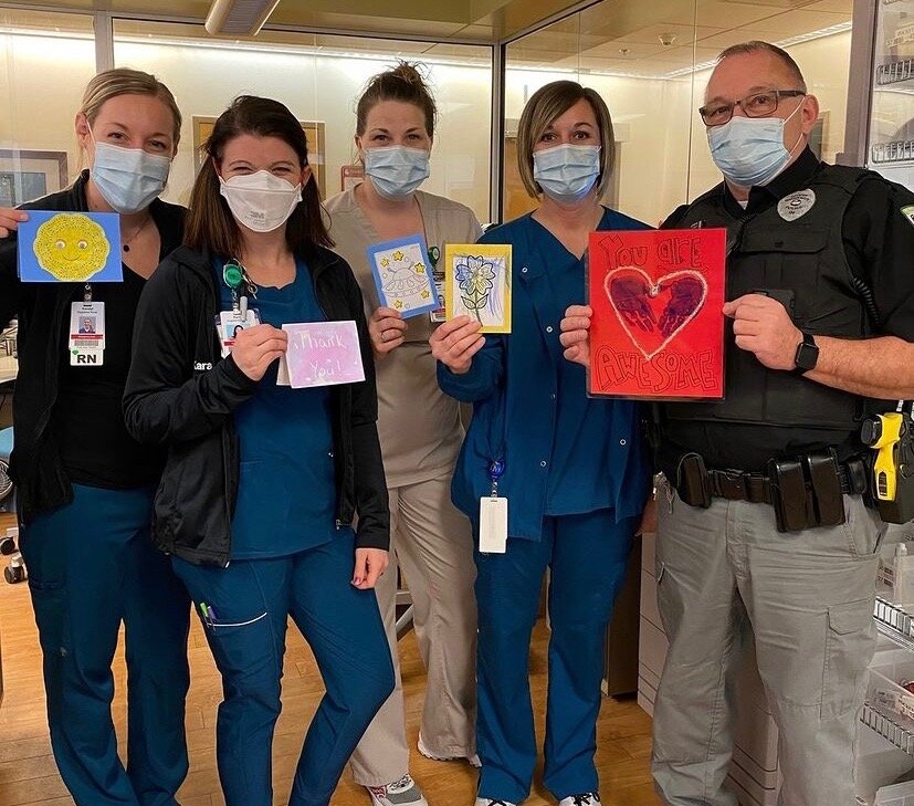 Co-workers at Parkview Huntington Hospital display some cards received from the community during the pandemic.