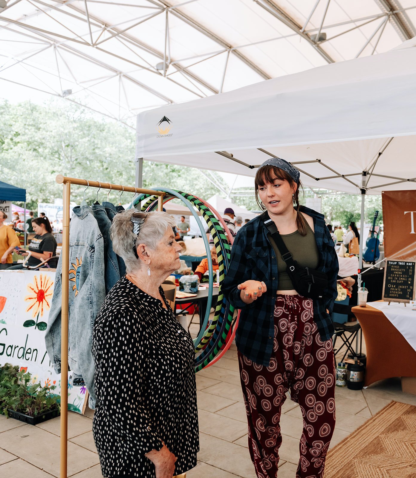 Julia Hyndman talks with vistors at her booth at Garden Night Market.